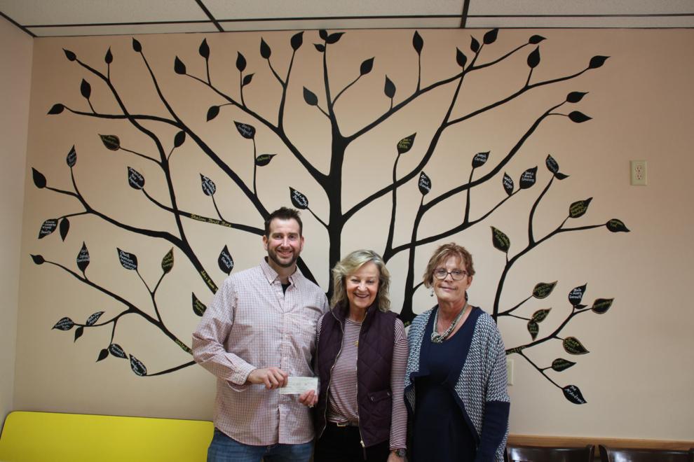Nate Dolan, (left) founder of Arms Reach Foundation, provided Jeannie Winselman (center) and Audrey Clough of the Senior Enrichment Center with a check for $1,000 to support their programming. Photo by Tiffany Kafer
